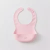 Pink silicone baby bib with food pocket and star detail