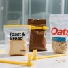 Reusable zipper bags with bread and oats sealed by yellow chip bag clips