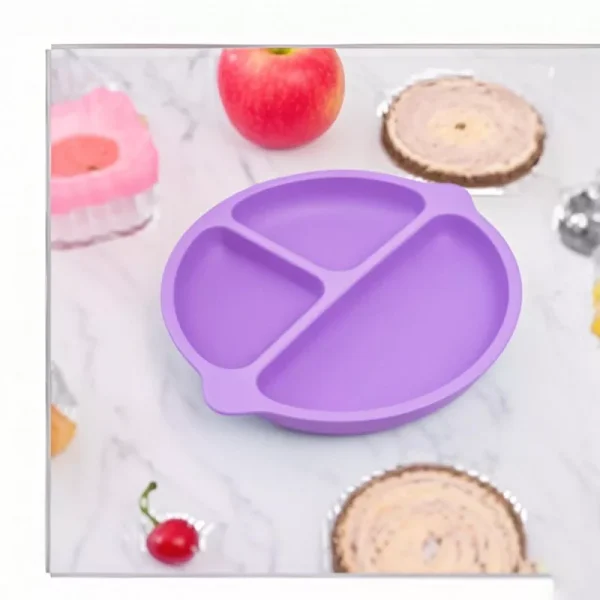 Purple silicone suction baby plate on marble table with fruit and snacks