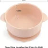 Peach silicone baby suction bowl with two side handles and measurement dimensions labeled