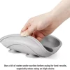 Gray silicone suction bowl being lifted to show strong grip and flexibility for baby feeding