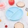 Light blue silicone baby suction plate with three compartments on marble surface