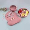 Dusty pink silicone baby feeding set with bib, bowl, utensils, and divided plate