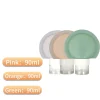 Round silicone travel bottles in pink, orange, and green, each with 90ml capacity for lotion or toiletries