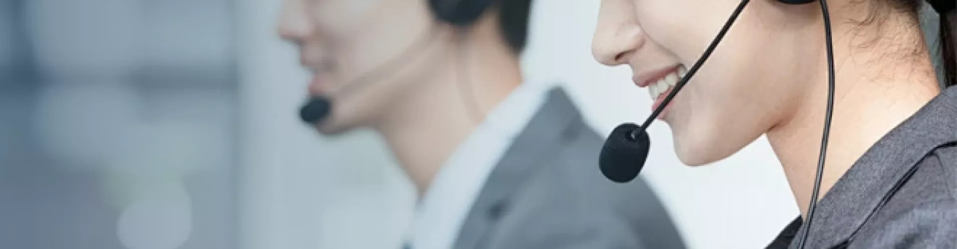 Smiling customer service representatives with headsets, close-up view, UnionSilic contact banner