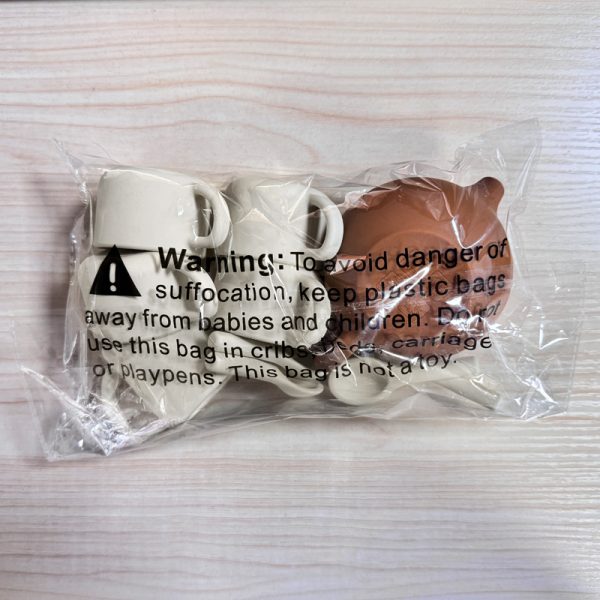 Back of Packaged Silicone Tea Set with Warning Label