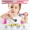 Baby Training Spoon and Fork Set Baby holding training spoon and fork set with soft handles.