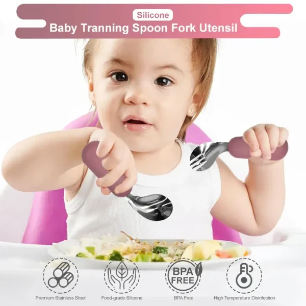 Baby Training Spoon and Fork Set Baby holding training spoon and fork set with soft handles.