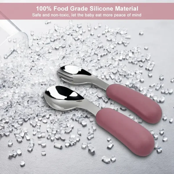 Food-Grade Baby Spoon and Fork Pink-handled baby spoon and fork on food-grade silicone granules background.