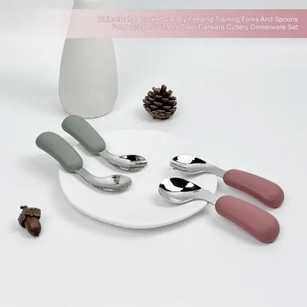 Baby Feeding Utensil Set Display Two sets of baby spoons and forks with green and pink handles displayed on a plate.