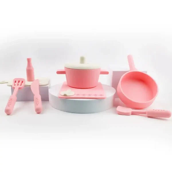 Pink silicone cookware play set with utensils.