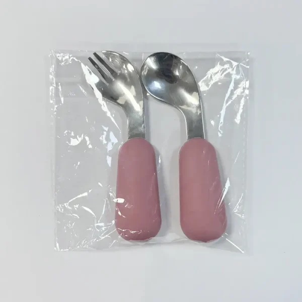 Packaged Baby Spoon and Fork Set Pink-handled baby spoon and fork set sealed in clear plastic packaging.