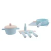 Pink silicone cookware play set on white table.