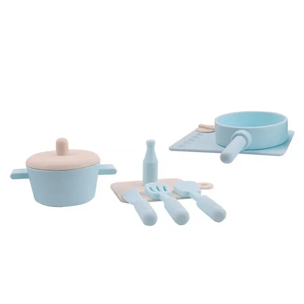 Pink silicone cookware play set on white table.