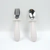 Gray Silicone Toddler Feeding Kit Gray silicone baby feeding set with bowl, cup, spoon, fork, and bib.
