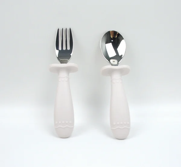 Gray Silicone Toddler Feeding Kit Gray silicone baby feeding set with bowl, cup, spoon, fork, and bib.