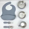 Premium gray silicone feeding set including bib, bowl, cup, spoon, and fork. Gray silicone toddler meal kit with bib, bowls, cup, and utensils.