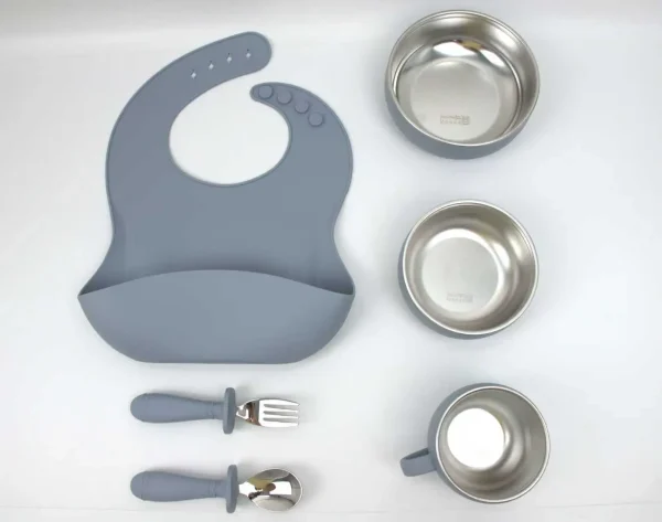 Premium gray silicone feeding set including bib, bowl, cup, spoon, and fork. Gray silicone toddler meal kit with bib, bowls, cup, and utensils.