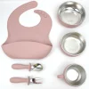 Dusty Pink Toddler Feeding Set Dusty pink toddler meal kit with bib, bowl, cup, spoon, and fork.