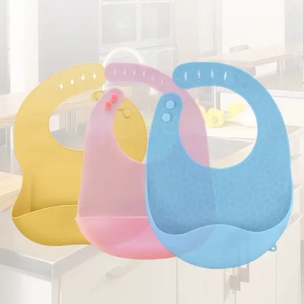 Pink silicone baby bib with food-catching pocket.